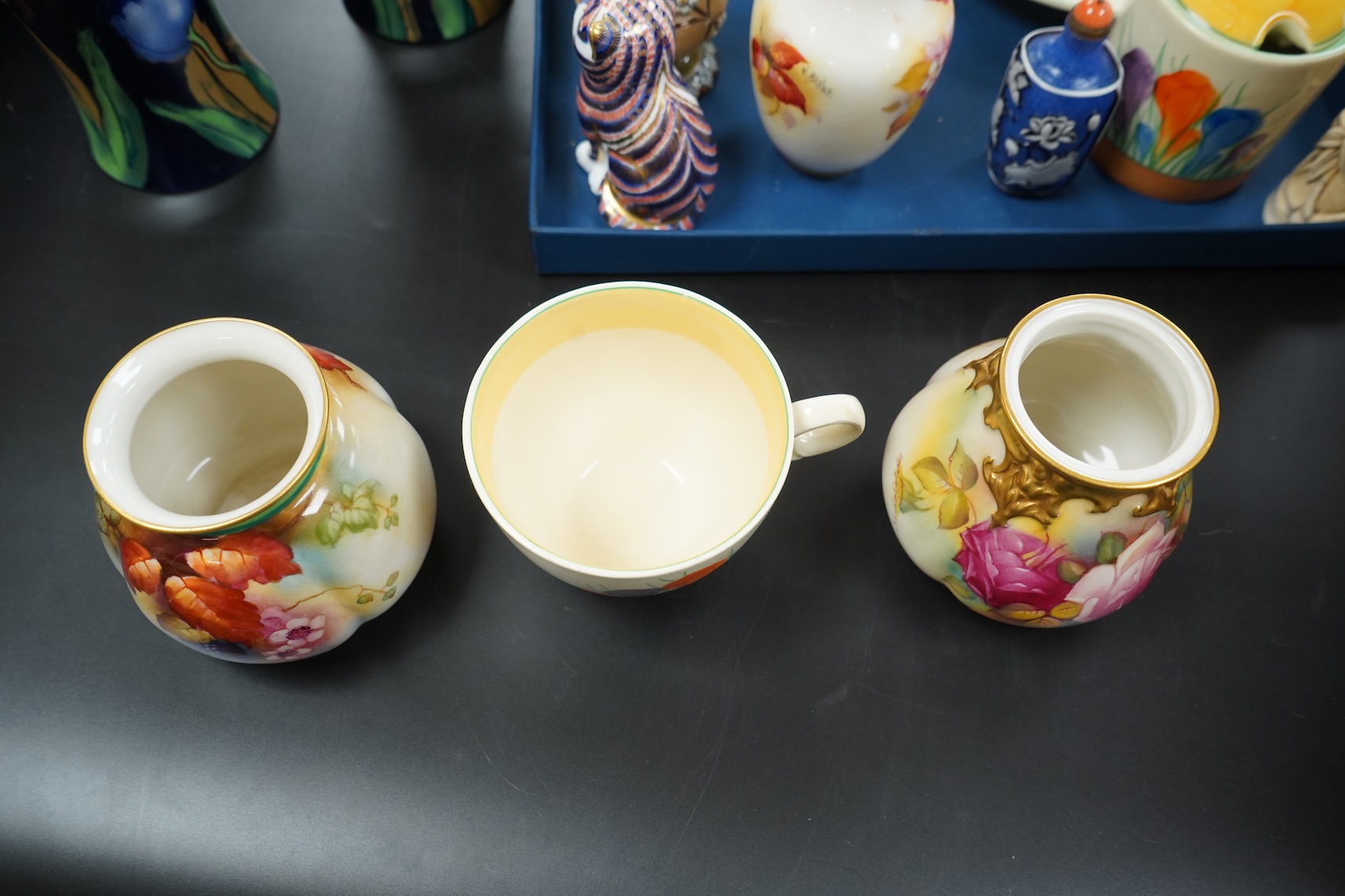 A collection of mixed porcelain and pottery to include four Worcester vases, one signed H. Blake, Clarice Cliff crocus pattern cup, saucer and sugar bowl and two Doulton Imari paperweights, largest 13cm high